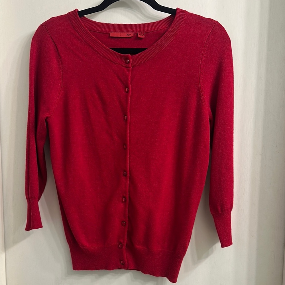 Red cardigan sweater with long sleeves and a round neckline